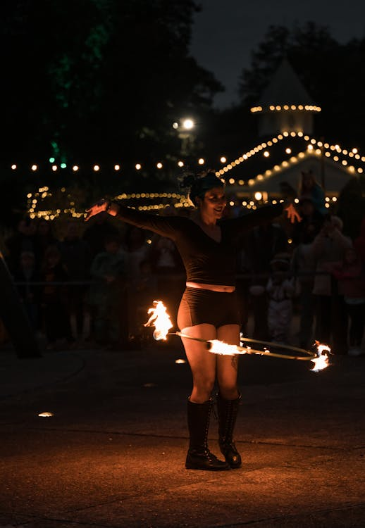 A person engaging in a fire hoop dance